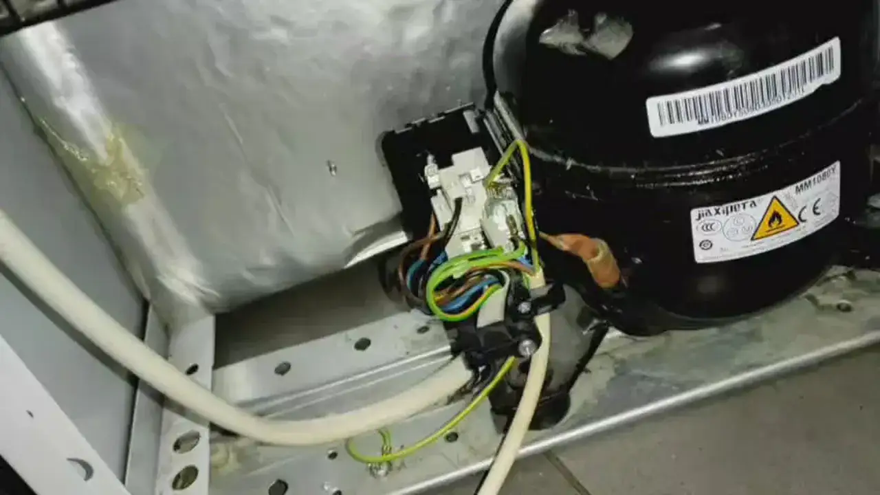Kompresor lodówki Beko nie chłodzi. Widoczne przewody i elementy elektryczne.